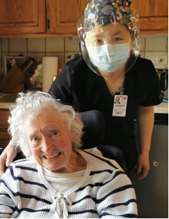 Healthcare worker posing with an elderly patient