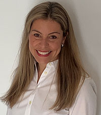 A portrait of Dr. Rebecca Stoller smiling and wearing a white shirt.
